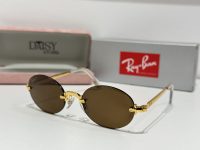 Ray-Ban sunglasses with gold frame and brown lenses displayed elegantly.