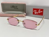 Ray-Ban sunglasses with pink lenses and gold frames, stylish and protective.