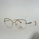 Elegant women's optical frames with gold and green accents.