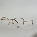 Elegant women's optical frames with gold accents on white background.