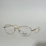 Elegant women's optical frames with gold accents, stylish design.