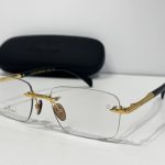 Skelete Optike David Beckham glasses with gold accents and case.