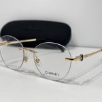 Chanel glasses with gold accents and case, elegant and stylish design.