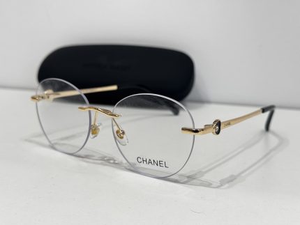 Chanel glasses with gold accents and case, elegant and stylish design.