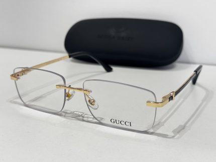 Gucci eyeglasses with gold accents and case, elegant design.
