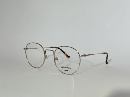 Elegant women's optical glasses with round frames and metal finish.