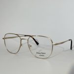 Elegant women's optical glasses with gold frame.