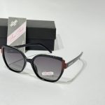 Anna Smith sunglasses with elegant black and red frame.