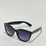 Black cat-eye sunglasses with polarized lenses on white background.
