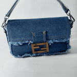 Denim Fendi Baguette bag with frayed edges and metal clasp.