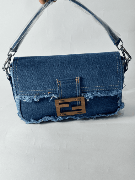 Denim Fendi Baguette bag with frayed edges and metal clasp.