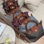 Colorful Longchamp Le Pliage Small bags on sofa display.