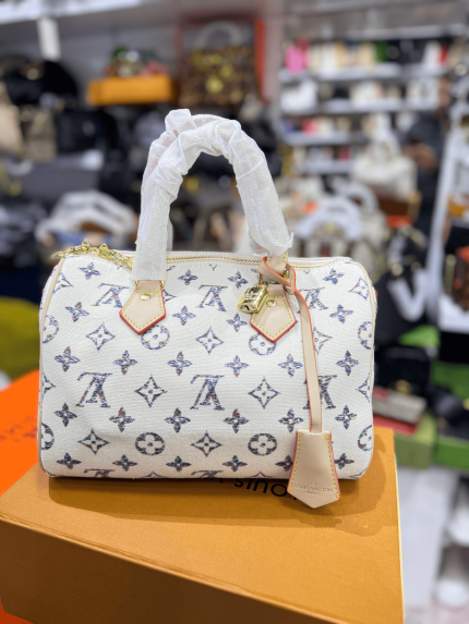 Louis Vuitton Speedy handbag with monogram pattern on display.