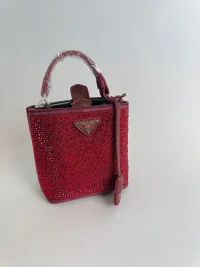 Red women's handbag with sparkling rhinestones and handle.