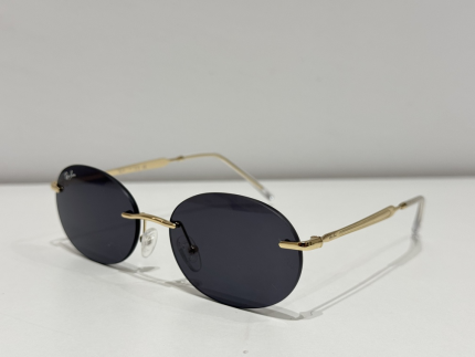 Syze dielli Ray-Ban me kornizë të artë dhe lente të errëta për mbrojtje dhe stil.