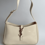 YSL Hobo beige handbag with logo clasp and strap.
