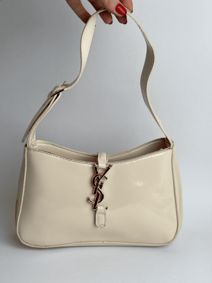 YSL Hobo beige handbag with logo clasp and strap.