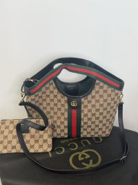 Gucci Ophidia GG shoulder bag with iconic monogram and stripe design.
