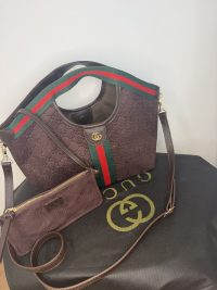 Gucci Ophidia GG shoulder bag with iconic stripe design.