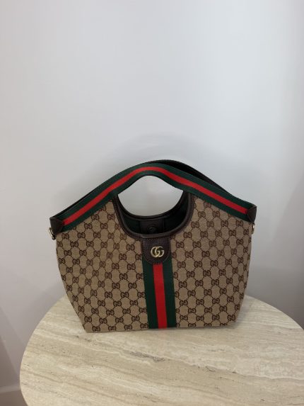 Gucci Ophidia GG shoulder bag with iconic stripe design.