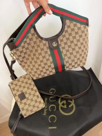 Gucci Ophidia GG shoulder bag with signature stripe and pouch.