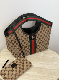 Gucci Ophidia GG shoulder bag with iconic stripe design.