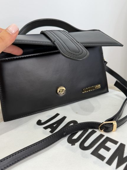 Cante Jacquemus Le Bambino black handbag on branded dust bag.