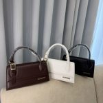 Jacquemus Le Chiquito Long bags in brown, white, black on display.