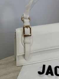 White Jacquemus Le Chiquito Long bag with gold buckle detail.