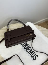 Jacquemus Le Chiquito Long brown handbag on white branded cloth.