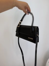 Black Jacquemus Le Chiquito Long handbag with gold logo and strap.