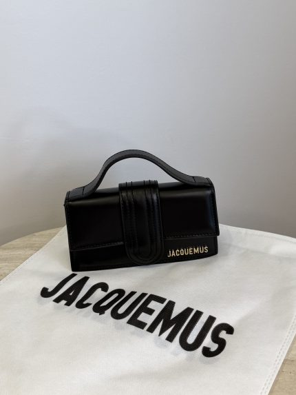 Black Jacquemus Le Bambino mini bag on branded cloth.