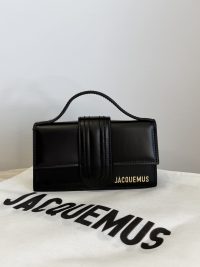 Black Jacquemus Le Bambino mini bag on branded dust bag.