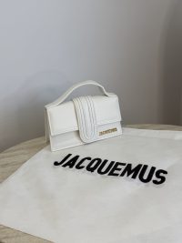 White Jacquemus Le Bambino mini bag on branded cloth.