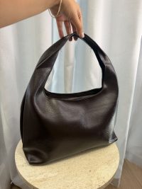 Elegant leather university bag on display table.