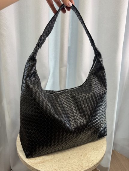 Elegant black woven leather hobo bag on display.
