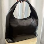 Elegant black leather hobo bag for versatile occasions.