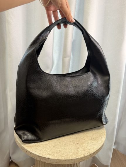 Elegant black leather hobo bag for versatile occasions.
