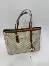Michael Kors university bag with logo pattern and brown straps.