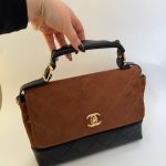 Chanel Flap suede kafe elegant handbag with black accents.