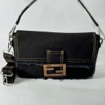 Fendi Baguette denim bag with buckle and strap.
