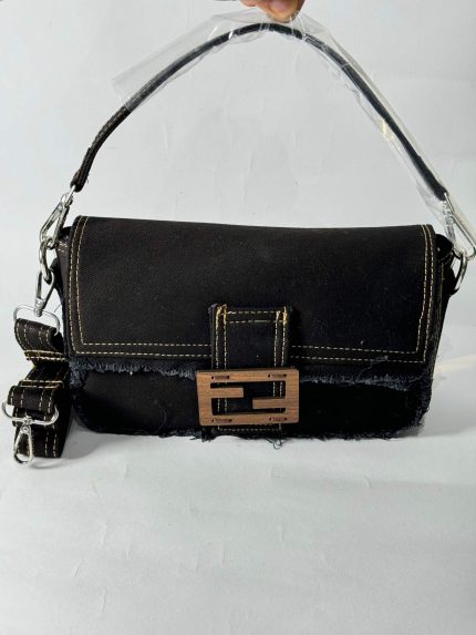 Fendi Baguette denim bag with buckle and strap.