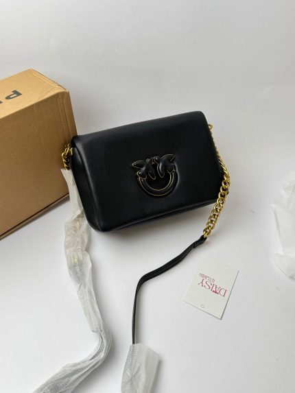Black Pinko Love Bag Puff with gold chain on display.
