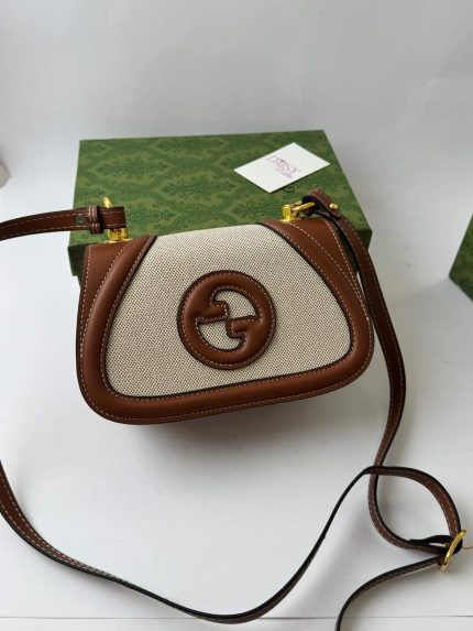 Gucci Blondie cream bag with brown leather accents and logo.