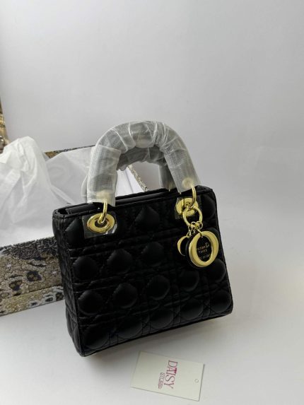 Black Dior Lady Dior Mini handbag with gold accents.