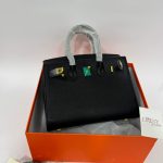 Hermès Birkin black handbag in box, elegant luxury style.