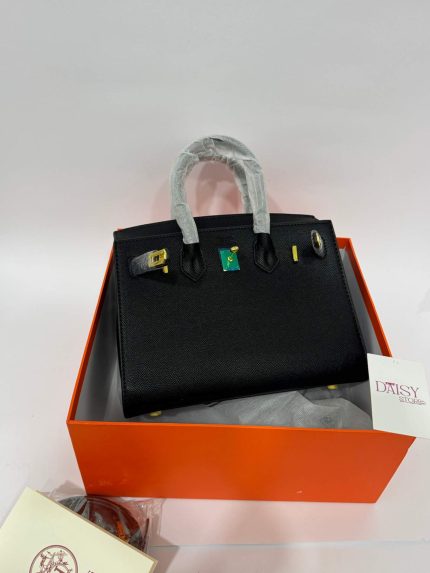 Hermès Birkin black handbag in box, elegant luxury style.