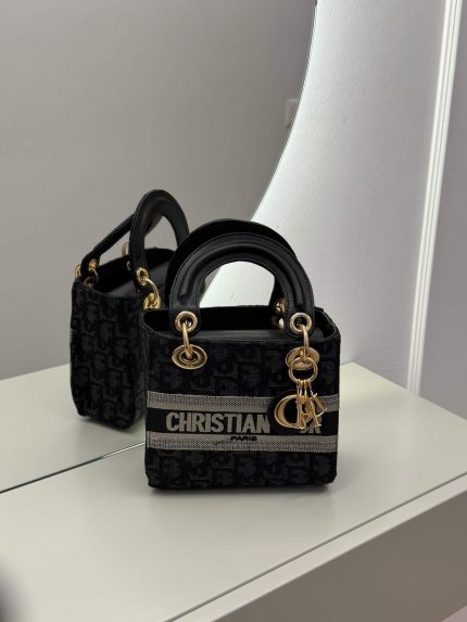 Dior Lady D-Lite Oblique handbag on mirrored surface.