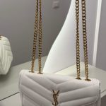 White Saint Laurent Loulou bag with gold chain straps.