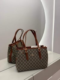 Gucci GG Supreme Tote with brown leather straps, elegant and functional design.